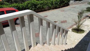 A staircase with a white railing leading to a higher floor.