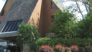 A modern building with a sloped roof and large windows.