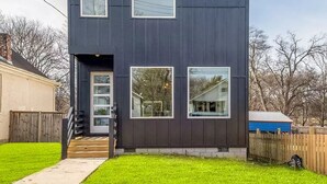 A modern two-story house with a dark exterior, large windows, and a visible address number. - New home in Nashville built in 2023! Extremely spacious, great for hosting
 (Nashville)