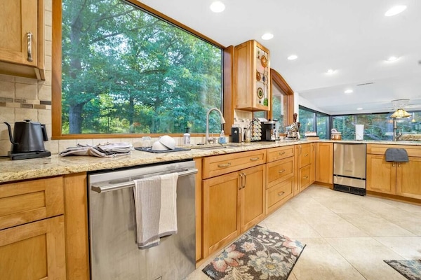 The main kitchen overlooks the pond and the Summer Kitchen.