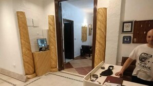 A room with a reception desk, a tiled floor, and a door leading to another room. - Family Palace Downtown Cairo  (Cairo)