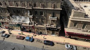 A multi-story building with a mix of residential and commercial spaces, including visible storefronts and balconies. - Family Palace Downtown Cairo  (Cairo)