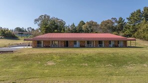 A single-story building with a red roof, a covered porch, and a grassy lawn. - Highfields - Valley Views - Bathurst Acreage (Robin Hill)