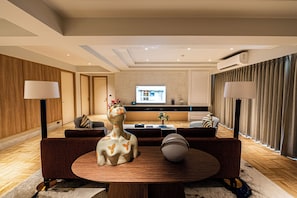 Executive Suite, 3 Bedrooms | Living room | 55-inch flat-screen TV with satellite channels