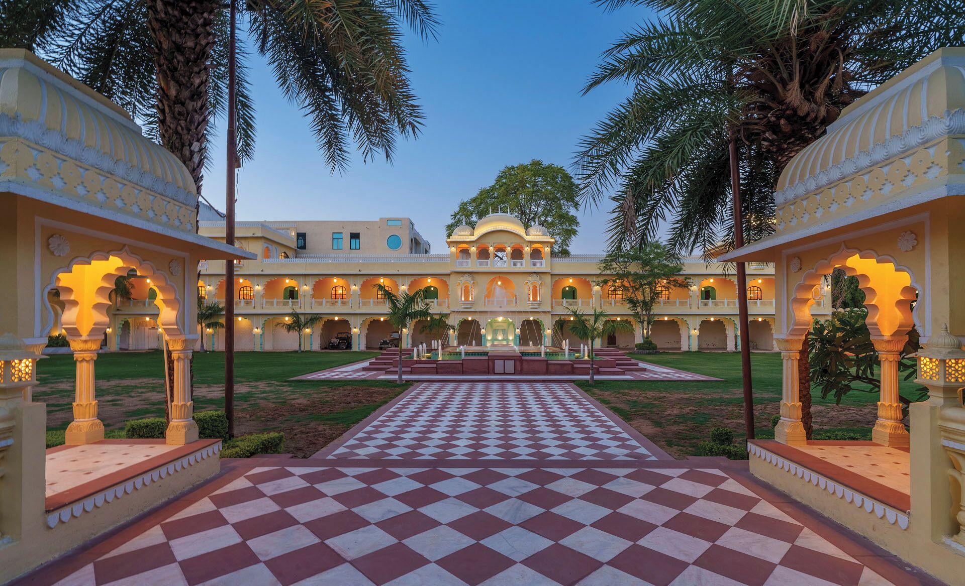 A traditional building with a central courtyard, multiple balconies, and ornate arches.