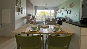 A modern kitchen with a dining area, a sofa, and a view of the outdoors. - Cosy  Apt on friar’s bay SxM . 2 min to the Friar’s Bay beach ,restaurants (Saint Martin)