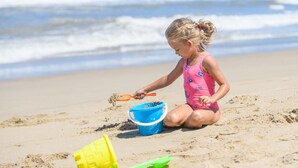 A child playing with sand on a beach. - San Lameer Villa 2704 (Southbroom)