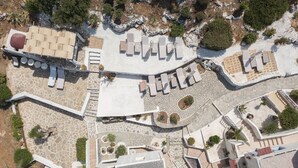 An aerial view of a resort with multiple lounge areas, a pool, and a landscaped garden. - Junior Villa for up to 10 vacationers full view (Piskopiano)