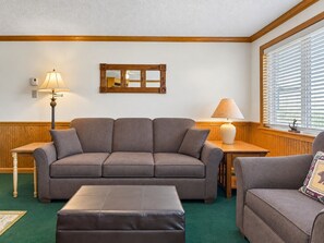 A living room with a sofa, ottoman, and two lamps. - Beautiful Views New Deck Wi-Fi (Snowshoe)