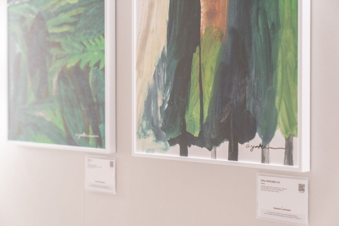 Two framed artworks on a wall.