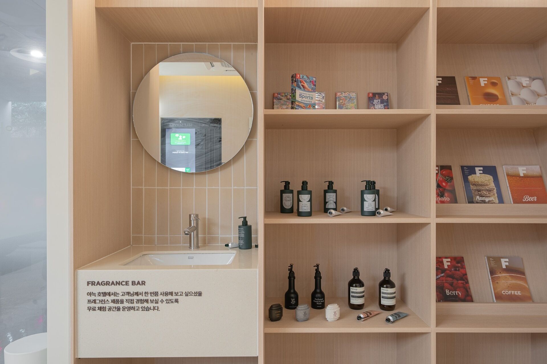 A bathroom with a mirror, sink, and shelves with toiletries and books.