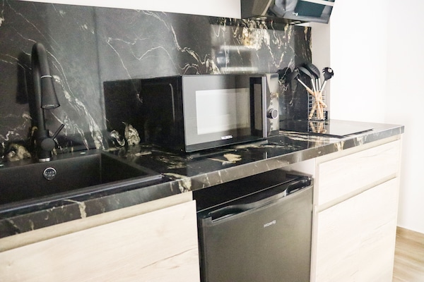 Apartamento família | Cozinha privada | Frigobar, micro-ondas, cooktop, máquina de café expresso