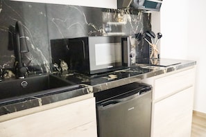 Apartamento família | Cozinha privada | Frigobar, micro-ondas, cooktop, máquina de café expresso