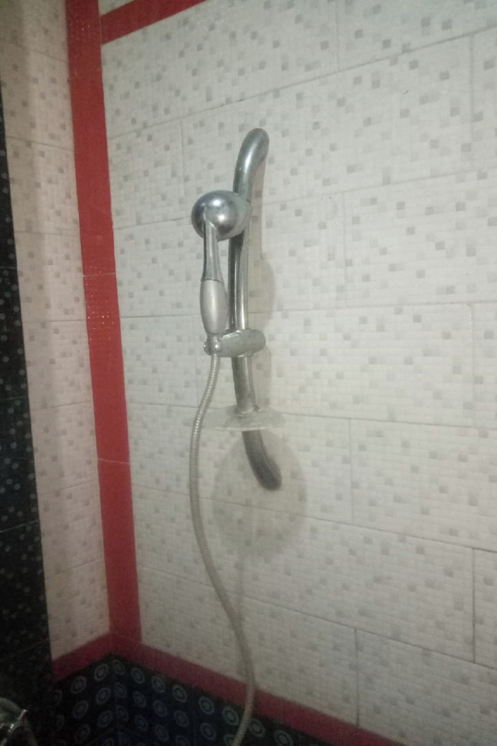 A shower with a handheld showerhead and a flexible hose.