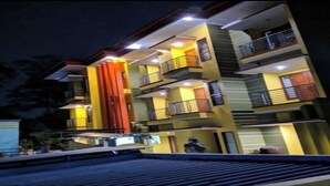 A multi-story building with balconies and a central staircase. - OYO Life 90646 Villa Karsinem Pasuruan (Prigen)