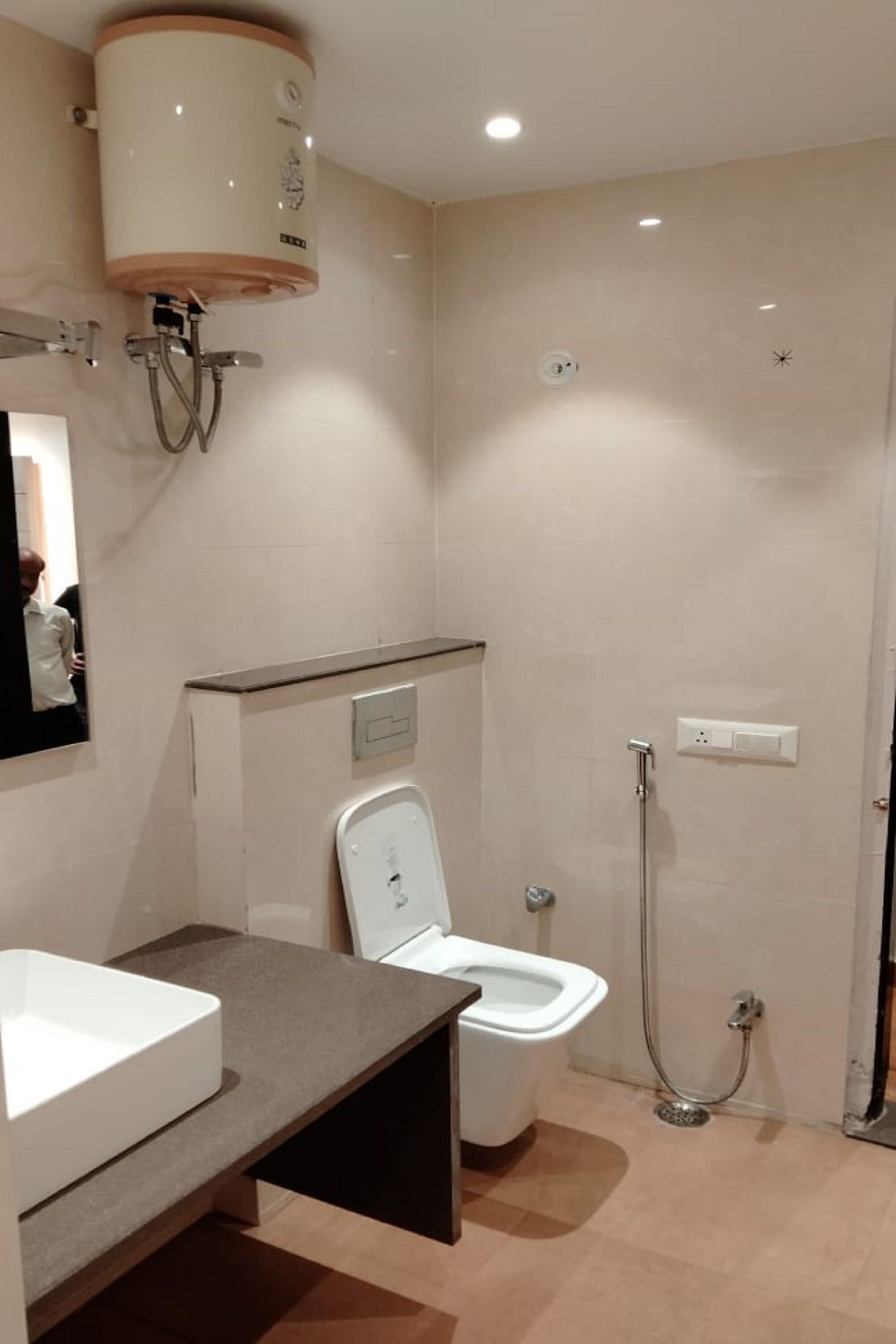 A modern bathroom with a toilet, bidet, and shower.