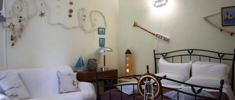 A bedroom with a bed, a nightstand, a lamp, a decorative wall, and a sign that says "Each Bar".