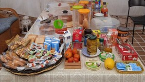 A table set up with various food items and condiments, including bread, cheese, and jars of preserves. - B&B La cascata (Noci)
