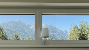 Una finestra con vista su una montagna e alberi.