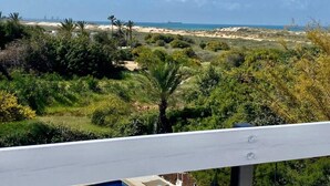 A coastal landscape with a view of the sea, sandy dunes, and dense greenery. - Miklat for 6/7, Family Villa By The Sea W Jacuzzi & Pool (Caesarea)