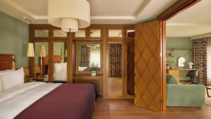 A hotel room with a large bed, a desk with a chair, a wardrobe, and a mirror. - Sir Devonshire Square Hotel, part of Sircle Collection (London)