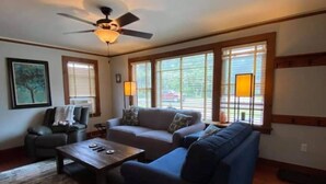A living room with a sofa, armchairs, a coffee table, and a ceiling fan. - Dog Friendly, located Between Lake Placid and Saranac Lake with pontoon rentals (Ray Brook)