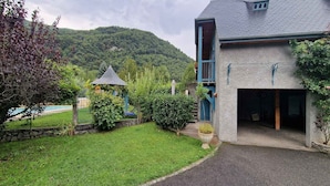 A house with a stone facade, a blue door, and a covered porch.