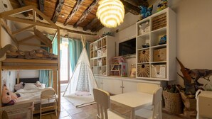 A child's bedroom with bunk beds, a play area, and a white table with chairs. - Boho-chic Villa in San Rafael 1min (Sant Antoni de Portmany)