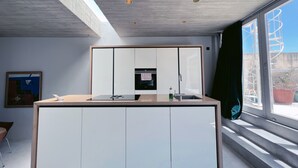 A modern kitchen with a built-in oven, a sink, and a countertop. - Nobile Apartments  (Valletta)