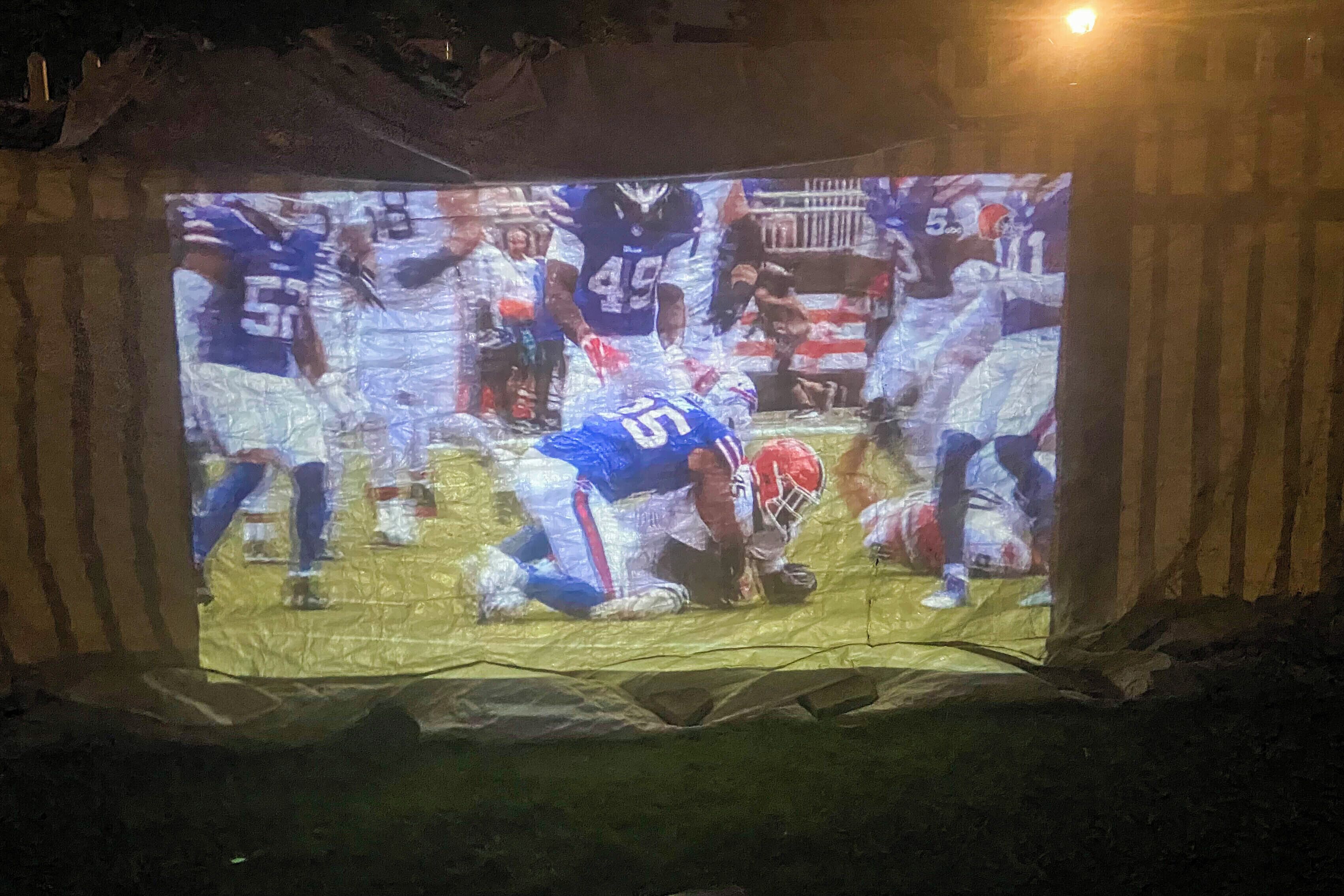 A projection screen displaying a sports event.