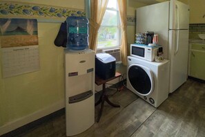 A compact kitchen with a refrigerator, microwave, and washing machine. - Rochester Escape w/ Hot Tub & Fire Pit! (Rochester)