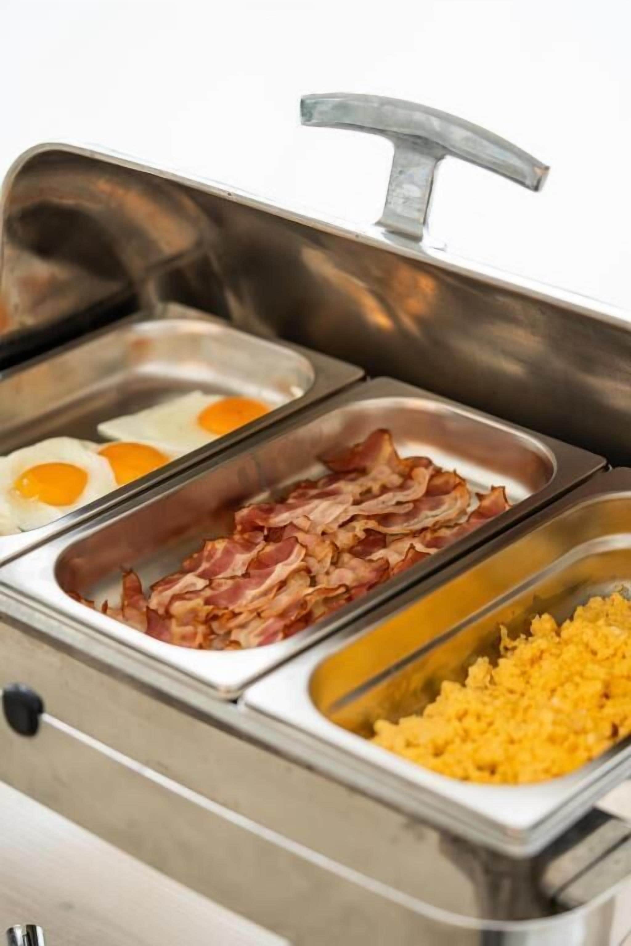 A buffet with options for eggs, bacon, and hash browns.