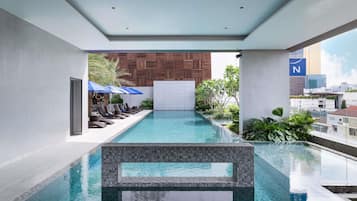 Outdoor pool, open 6:00 AM to 8:00 PM, pool umbrellas