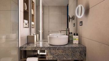 Un baño moderno con lavamanos redondo, toallero y estantes de almacenamiento.