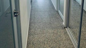 A hallway with a door on the left, a window with blinds in the center, and a door with glass panels on the right. - La Casa Blanca 1 (Carolina)