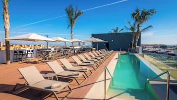 Een seizoensgebonden buitenzwembad en parasols bij het zwembad