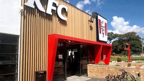 A KFC restaurant with a red awning and a logo sign. - Gorgeous 1-bed Apartment in Harare (Harare)