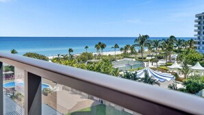 A resort with a pool, beach, palm trees, and a view of the ocean. - Cozy 2 Bedroom Ocean View / Beach Service / 707 (Miami Beach)