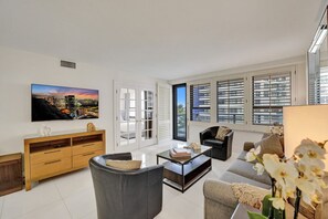 Relax in this stylish living room with a flat-screen TV, comfortable sofa, and glass coffee table.