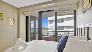 A hotel room with a bed, a window with a view of buildings, and a balcony. - Ocean View Condo / Beach Service & Pool / 618 (Miami Beach)