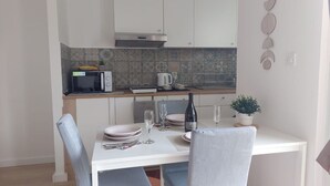 A compact kitchen with a microwave, kettle, and a small dining table set for two. - Apartment in Žaborić with Seaview, Balcony, Air condition, WIFI (5177-1) (Šibenik)