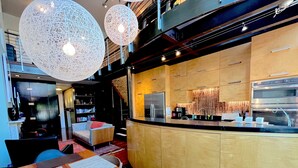A modern kitchen with wooden cabinets, a stainless steel refrigerator, and a coffee machine. - Modern 2 Bed 2 Bath & Sofa bed w/Dedicated workspace & Large Garden (Brooklyn)