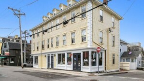 A two-story building with a ground-floor shop and upper residential units.