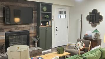 Smart TV, fireplace, books, printers