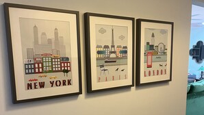 Three framed cityscape artworks on a wall. - Family Friendly 3 bedroom close to downtown Raleigh (Raleigh)