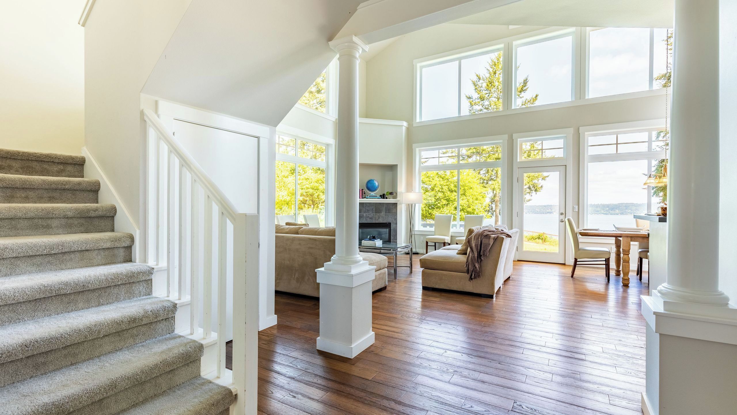 A spacious living area with a fireplace, a dining area, and a view of the outdoors.