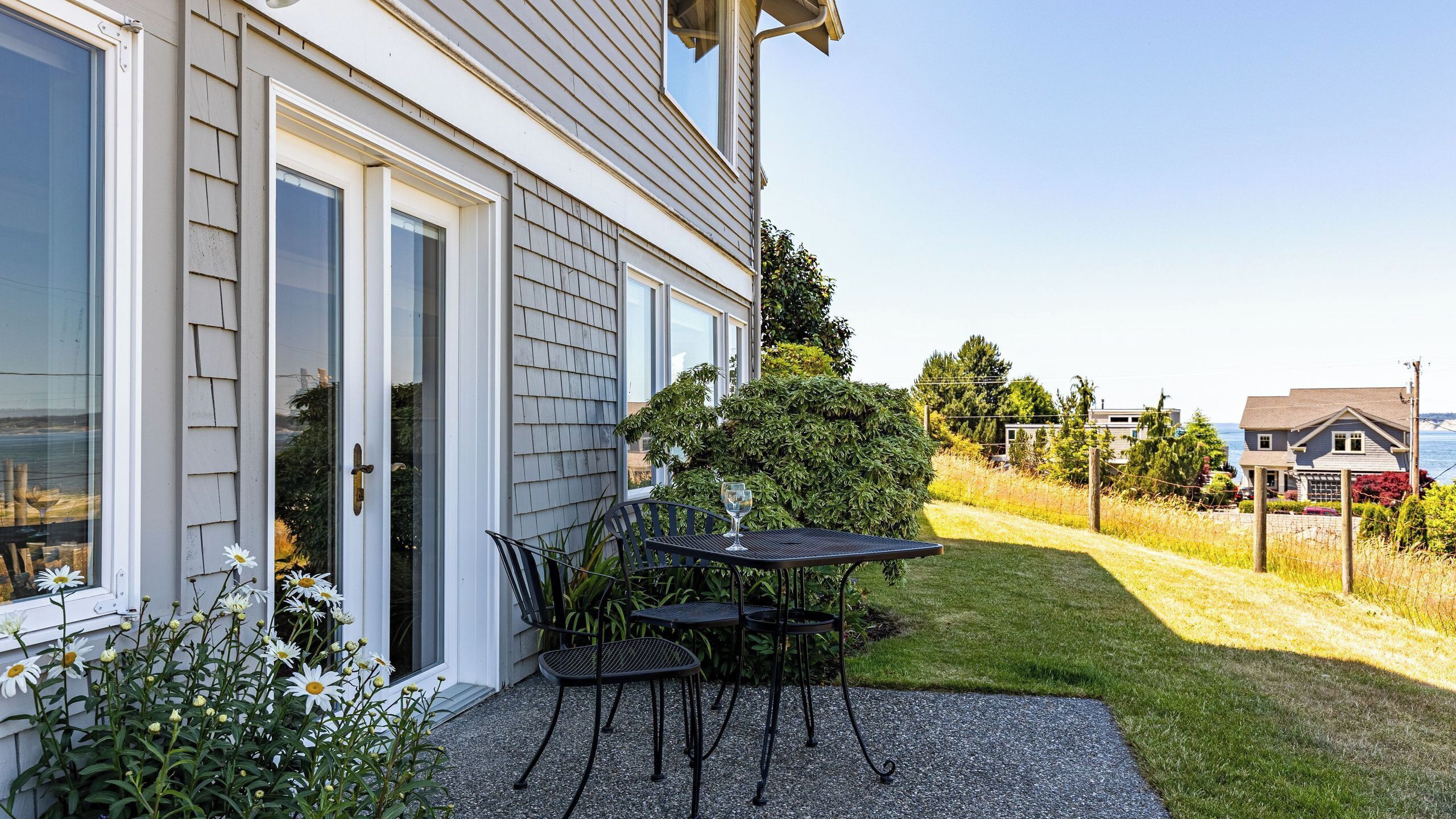 A house with a patio, a table, and chairs.