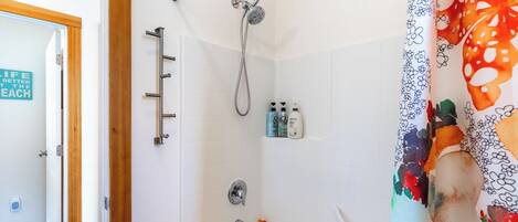 A bathroom with a shower, a bathtub, and a toilet.