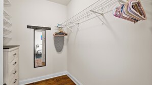 A laundry area with a drying rack, a mirror, and a wooden dresser. - North Center Chicago - Walkable - Transit Accessible - King & Queen Beds (Chicago)