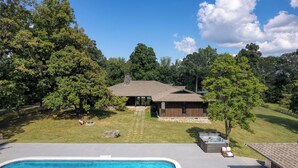 A house with a swimming pool, a hot tub, and a covered patio area. - Amber Lodge by Avantstay Pool, Firepit, Sauna (New Market)